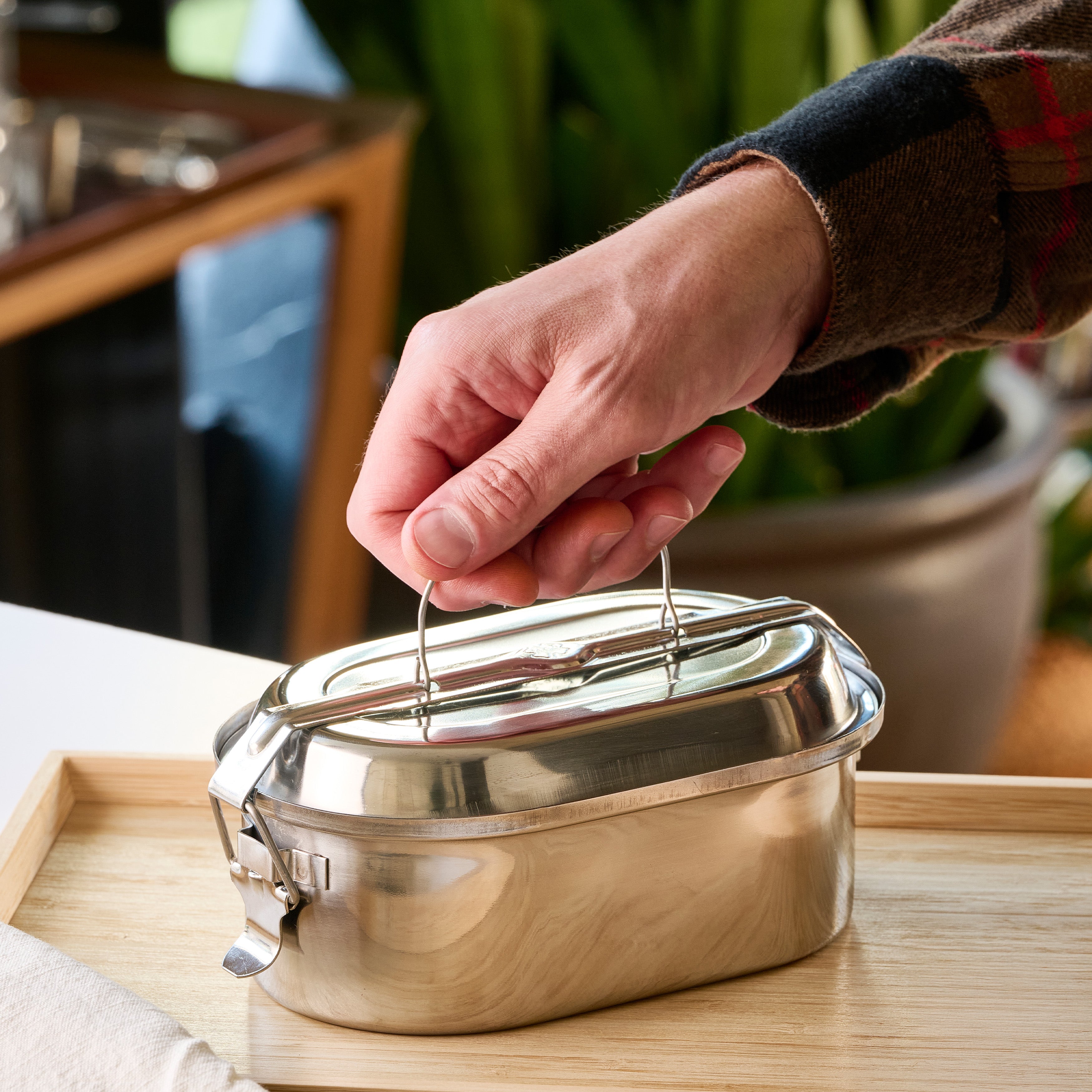 Stainless steel oval lunch box w/ 2 dishes.