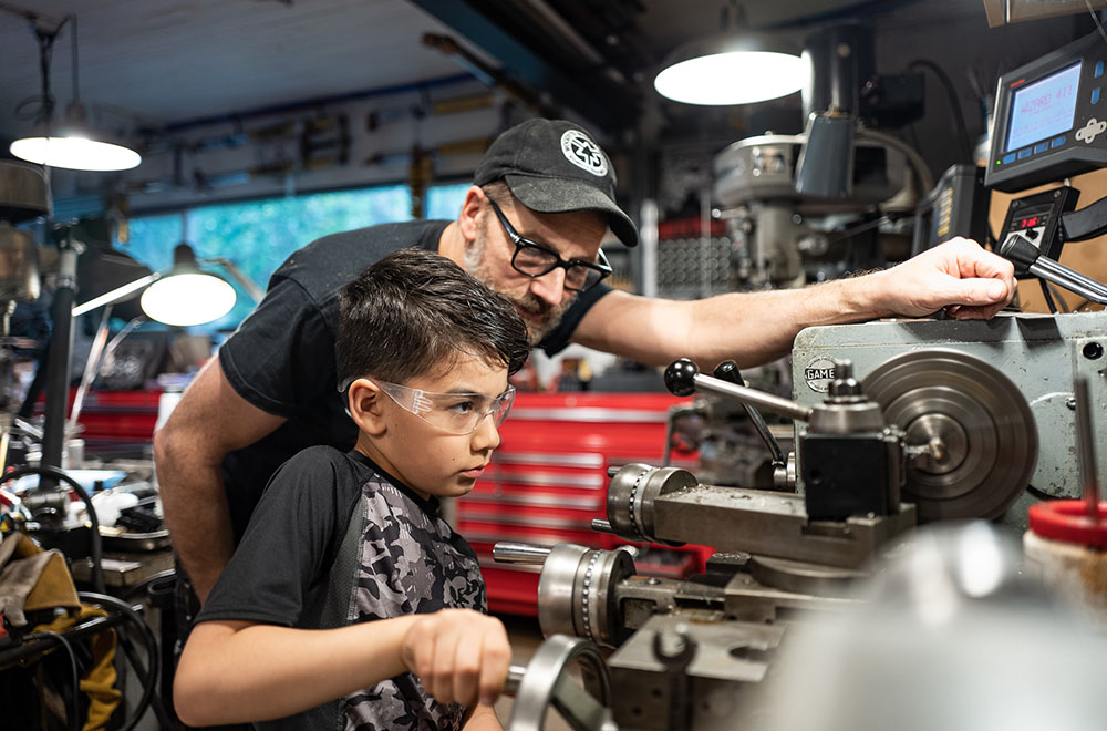 Gregor and son Lucas in metal shop